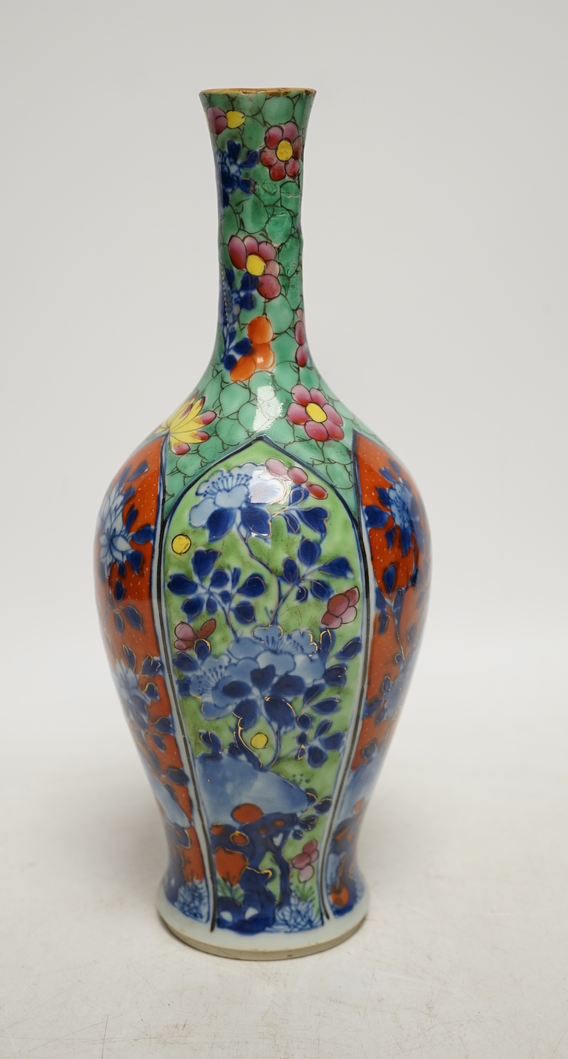 A Chinese clobbered blue and white bottle vase, Kangxi, 26cm high. Condition - ground off rim and hairline crack to neck